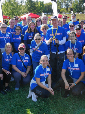 These are some of the walkers for Team JimmyB in 2022. Jim is standing to the right of center, wearing a ball cap and holding walking sticks.